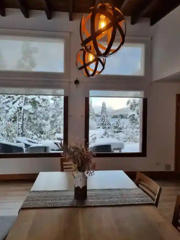 Dining room with lake view and snowy garden