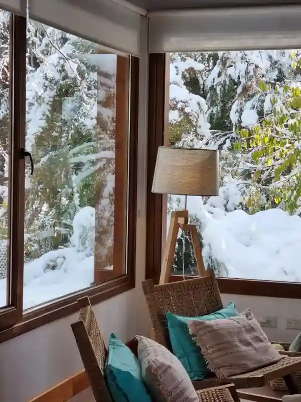 Cozy corner of the living room with the snowy garden in the background