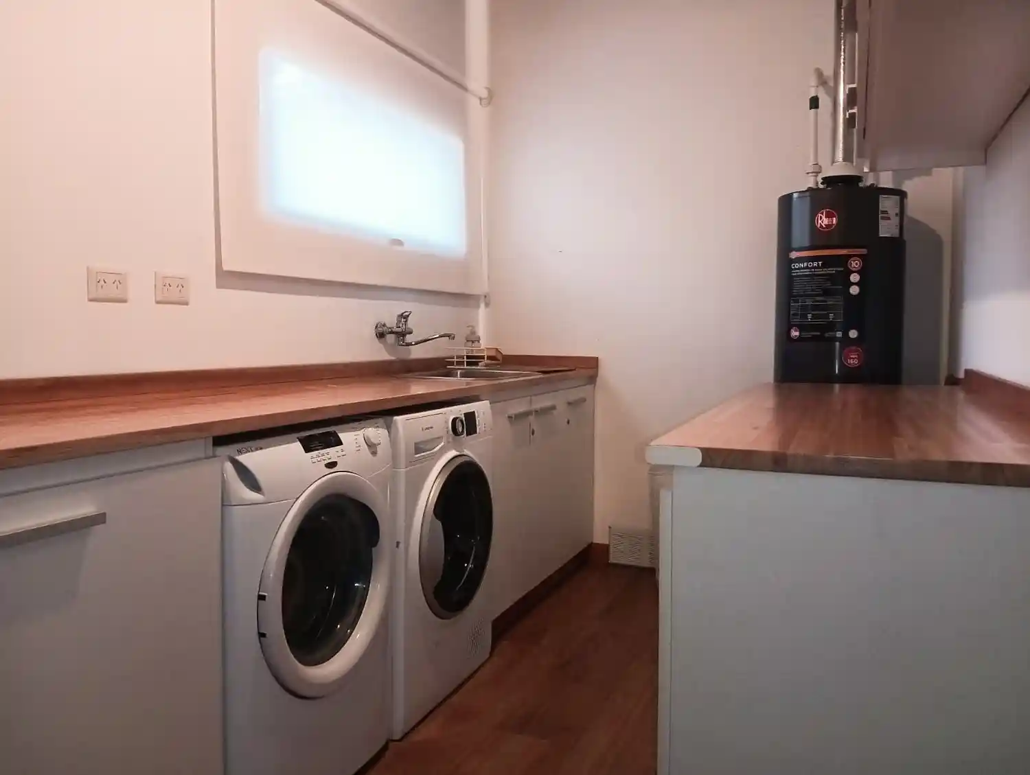 Large laundry room with washing machine and dryer