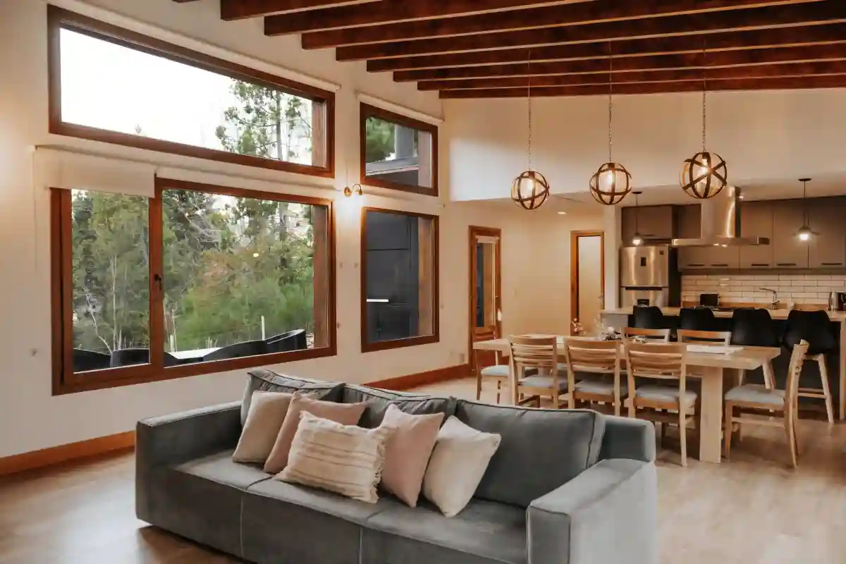 Living room and kitchen looking over the large windows with lake views