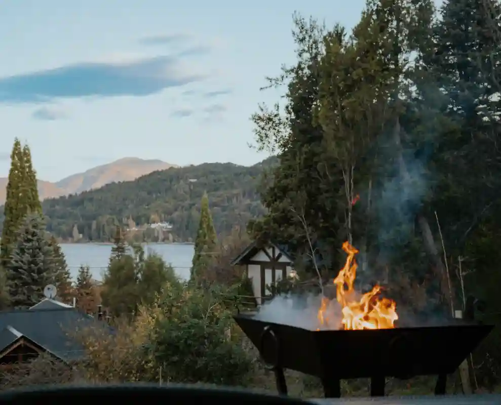 The brazier lit at sunset looking over the lake